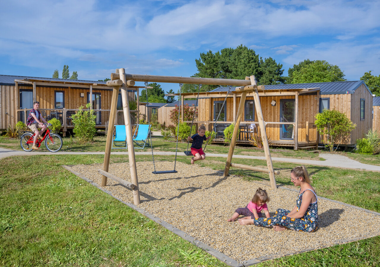 Playground, swing, mobile homes, family at CAPFUN Lac de Ribou in Cholet (49).