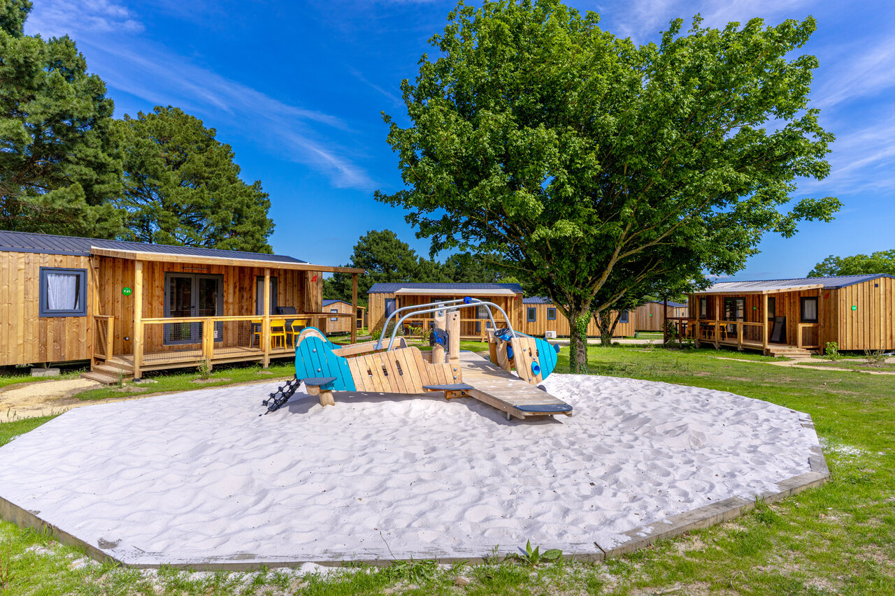 Wooden airplane playground, modern mobile homes at CAPFUN Lac de Ribou campsite in Cholet (49).