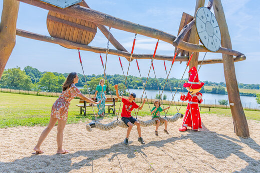 Children and mascot on giant swing at CAPFUN Lac de Ribou campsite, Cholet.