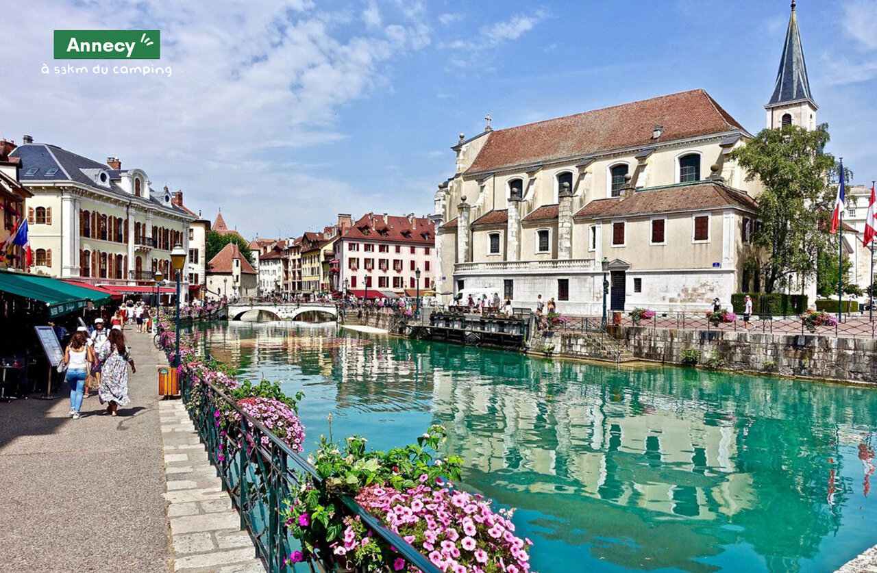 Flowery canal and historic buildings in Annecy, the Venice of the Alps.