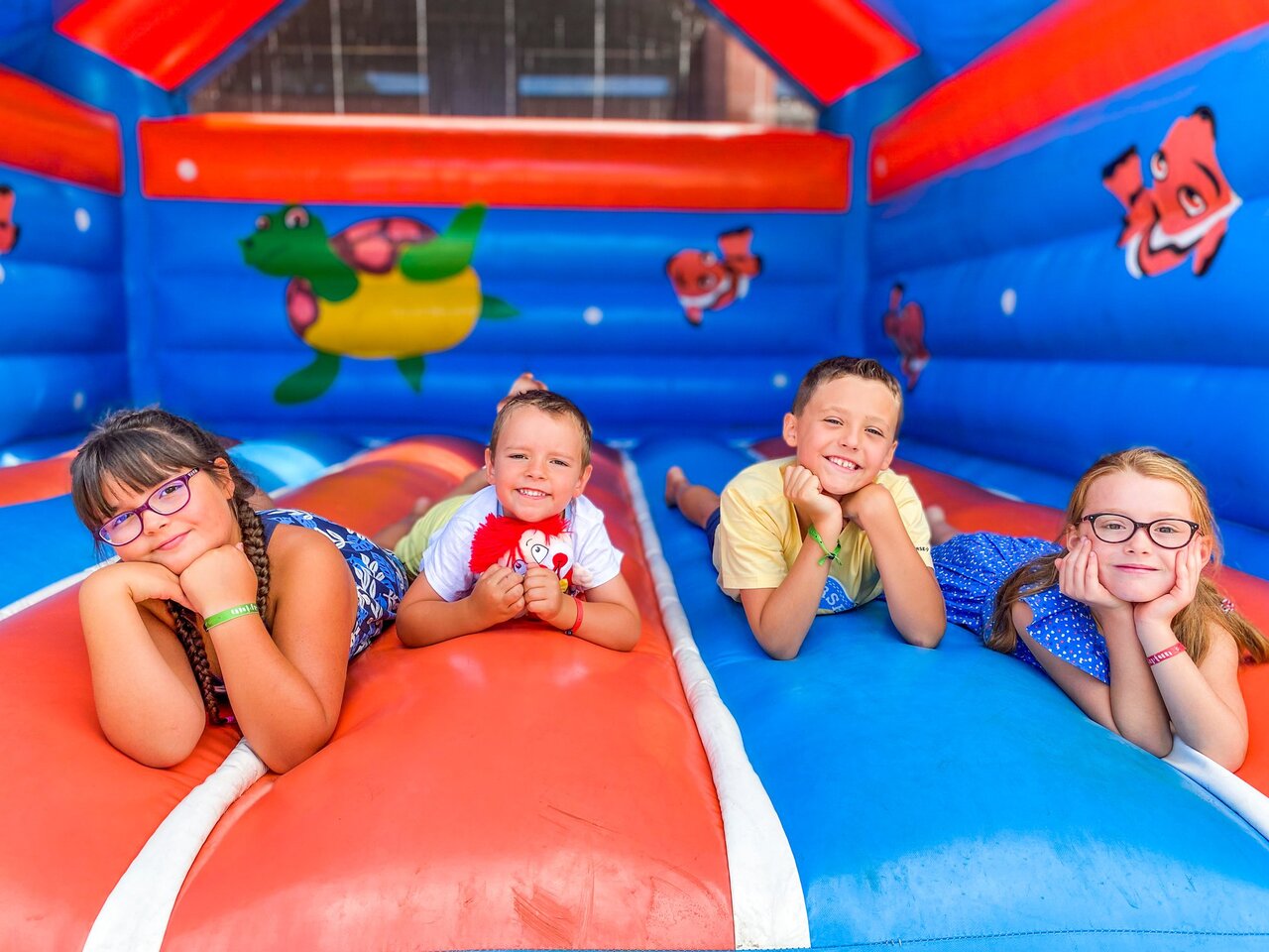 Smiling children on inflatable game at CAPFUN Landisland, Moliets-et-Maa (40).