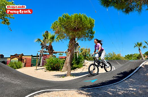 Pumptrack with cyclist at CAPFUN Las Bousigues campsite, Le Barcar�s.