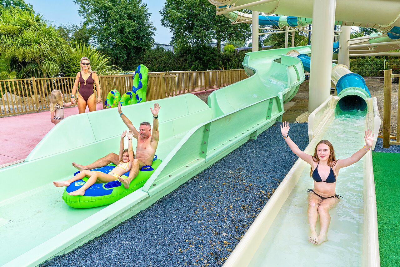 Family on water slides at VAGUES OCEANES Les Iles campsite in Hudimesnil (50).