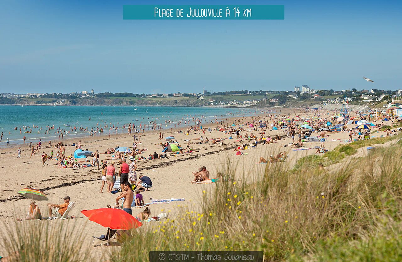 Jullouville beach, Normandy, with swimmers and fine sand.