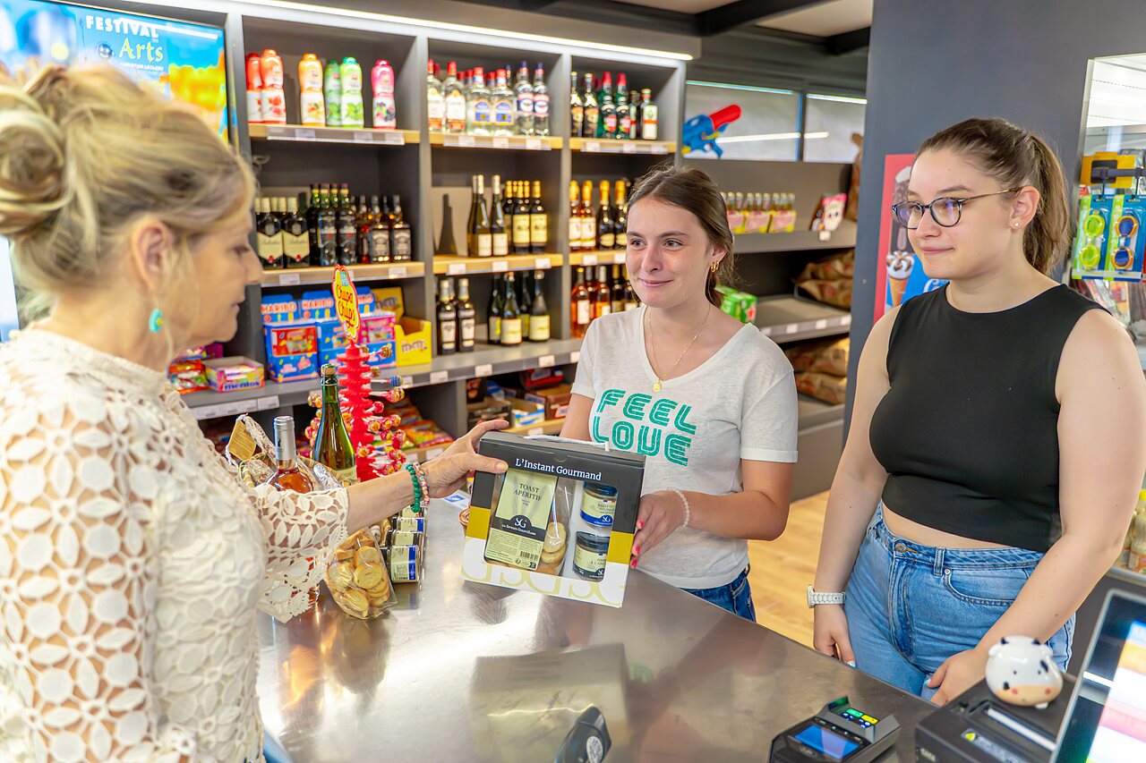 Customers buying local products at the grocery store of camping VAGUES OCEANES Les Iles in Hudimesnil (50).