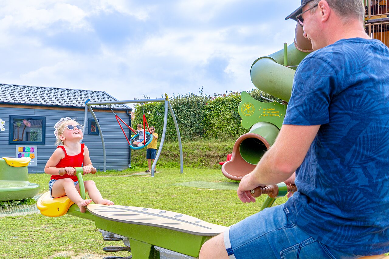Playground with seesaw and swing at VAGUES OCEANES Les Iles campsite.