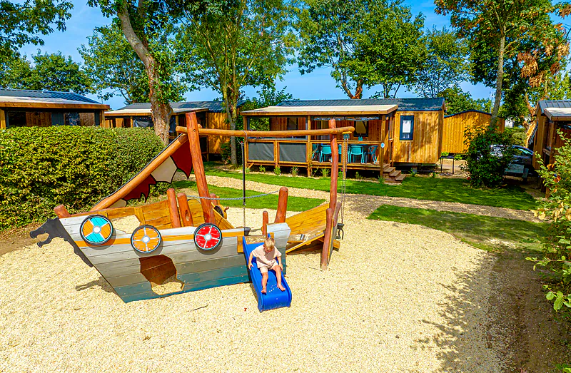 Viking ship playground and Mobile homes at CLICOCHIC Bellevue d'Erquy campsite (22).