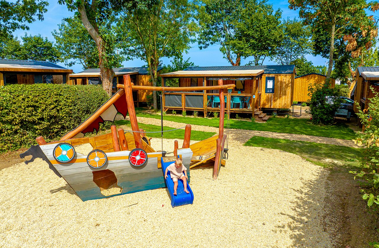 Viking ship playground and Mobile homes at CLICOCHIC Bellevue d'Erquy campsite (22).
