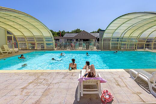 Covered outdoor swimming pool with bathers at CLICOCHIC Bellevue d'Erquy campsite (22).