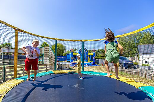 Children jumping on safe trampoline at CLICOCHIC Bellevue d'Erquy (22).