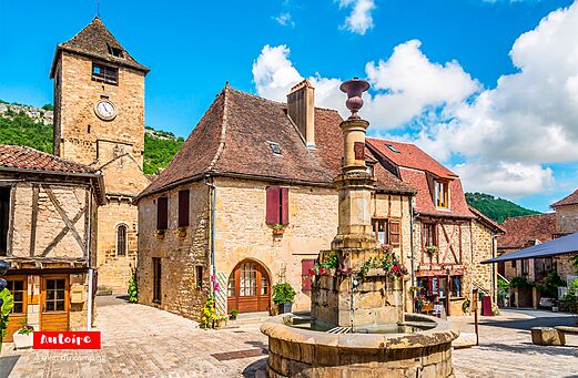 Medieval village square of Autoire with fountain and clock tower, Lot.