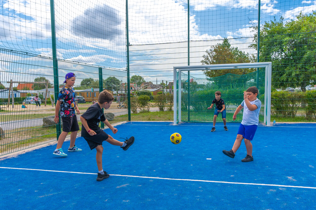 Children playing football, multi-sport pitch, VAGUES OCEANES Licorne campsite, Dunkerque.