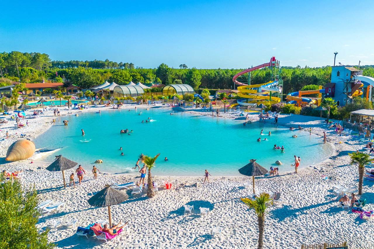 Large lagoon pool with sandy beach and waterslides at CAPFUN Lila campsite in LINXE (40).