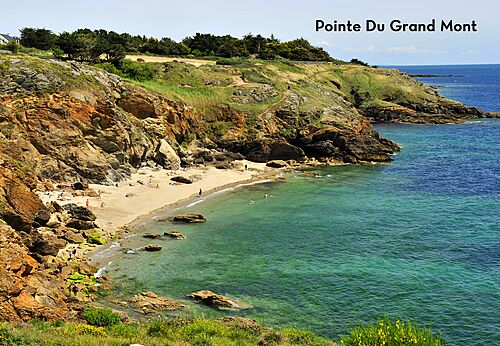 Sandy beach and rocky cliffs at Pointe du Grand Mont in Brittany.