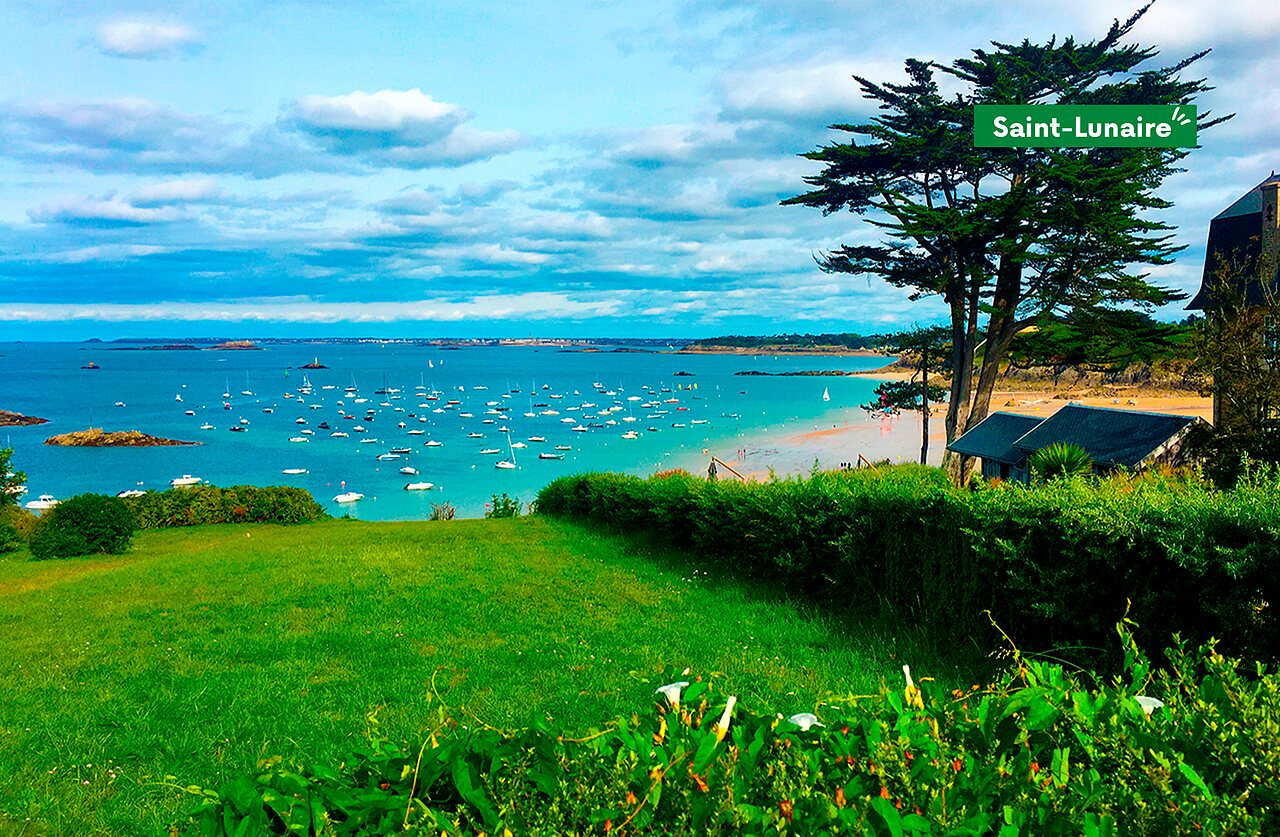 Beach and bay of Saint-Lunaire, Brittany, with many boats at anchor.