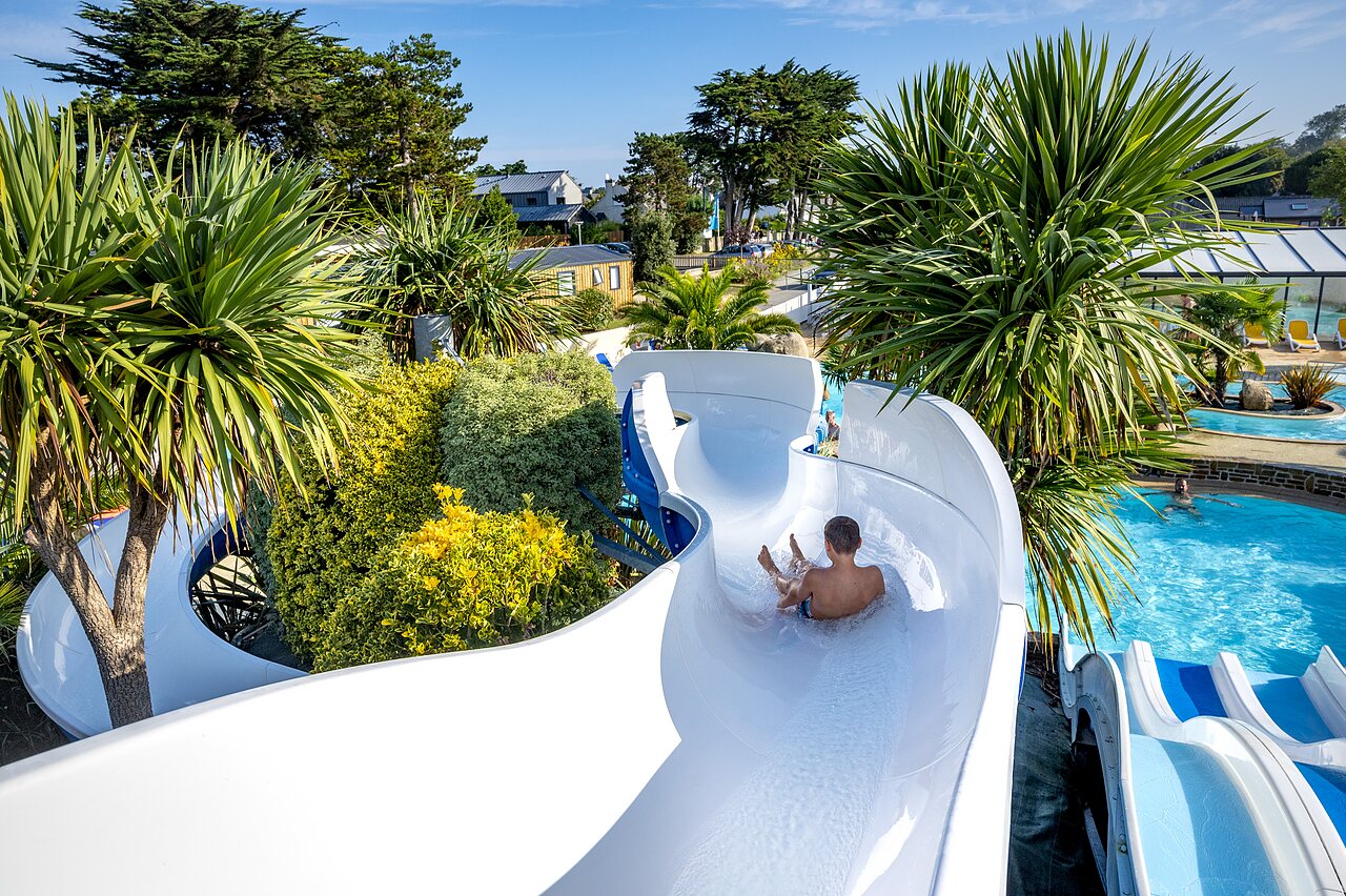 Water slide, child in pool at CLICOCHIC Longchamp campsite (35).