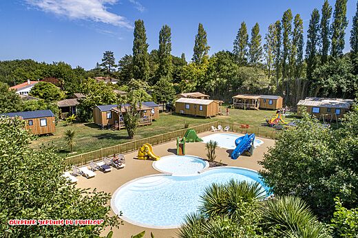 Aerial view pool with slides and mobile homes at CAPFUN Lou Puntaou campsite in LEON (40).