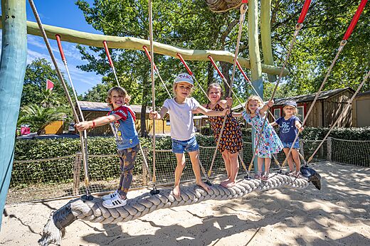 Smiling children playing on playground structure at CAPFUN Lou Puntaou campsite in LEON (40).