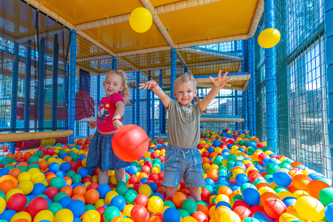 Children playing in a ball pit at CAPFUN Madrague campsite in PORNIC (44).