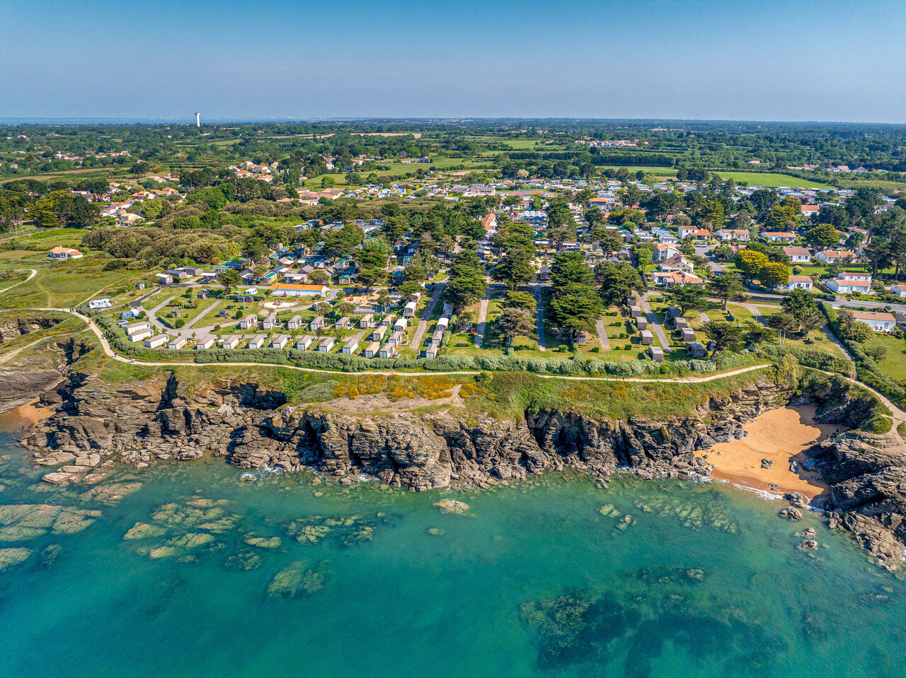 Aerial view of campsite with Mobile homes, sea and beach at CAPFUN Madrague campsite in PORNIC (44).