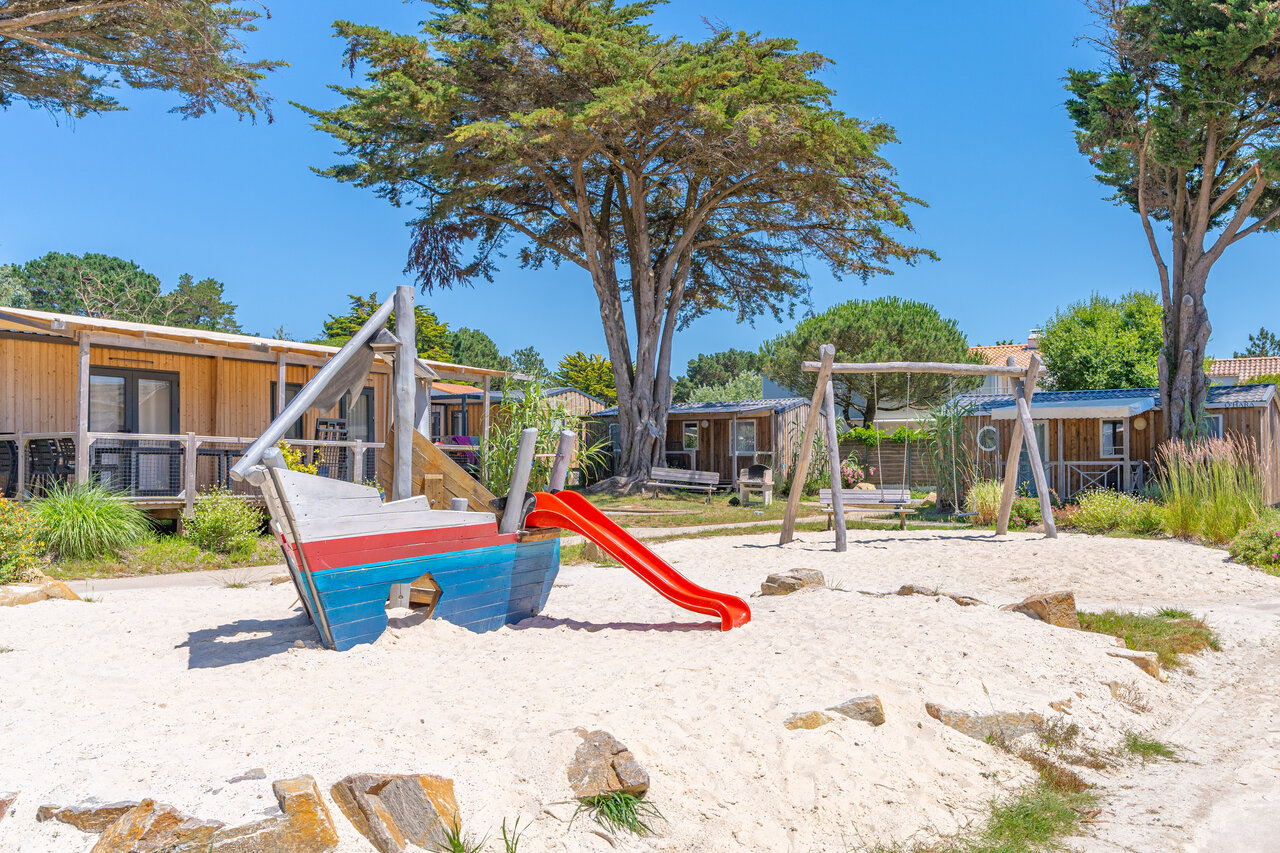 Playground with boat, slide and swing at CAPFUN Madrague campsite in PORNIC.