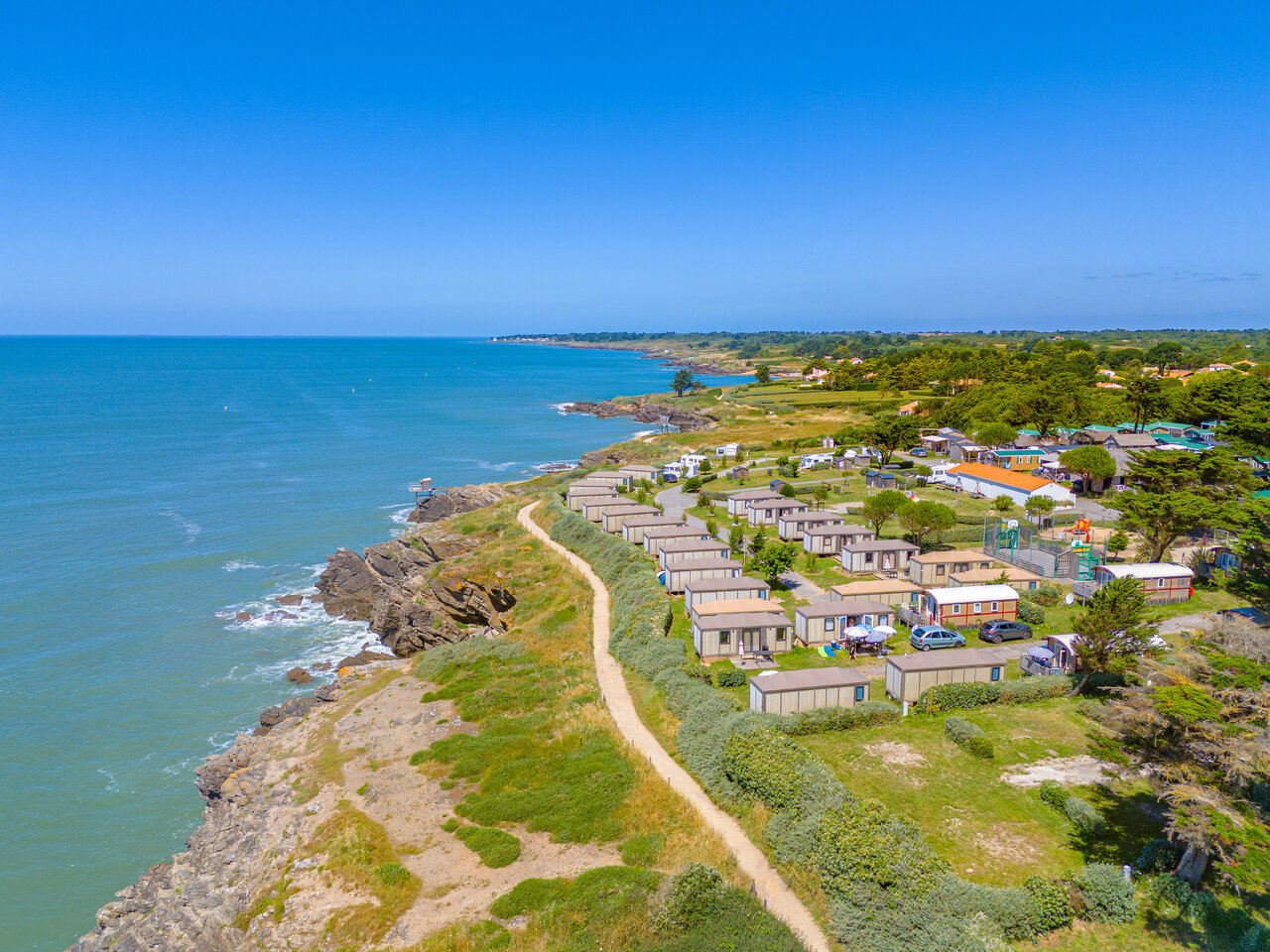 Mobile homes and rocky coastline, aerial view at CAPFUN Madrague campsite in PORNIC (44).