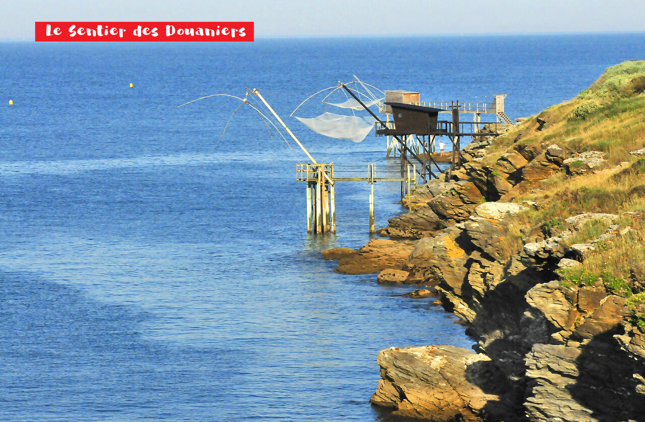 Traditional fishing huts (carrelets) and coastal path near Pornic, Atlantic coast.