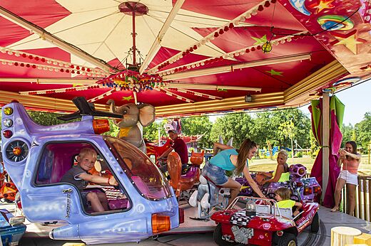 Children's carousel with helicopter and car at CAPFUN Mael campsite in ARGELES SUR MER.