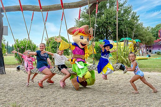 Giant swing, children and mascot at CAPFUN Mael campsite in ARGELES SUR MER.
