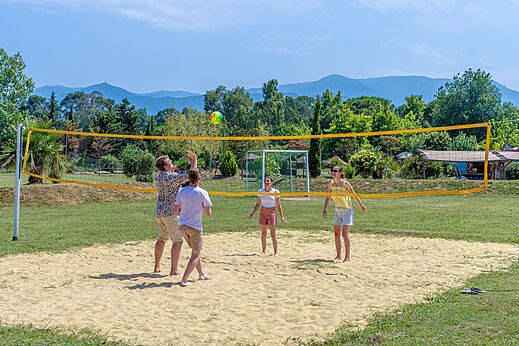Sand beach volleyball court with vacationers at CAPFUN Mael campsite in ARGELES SUR MER.