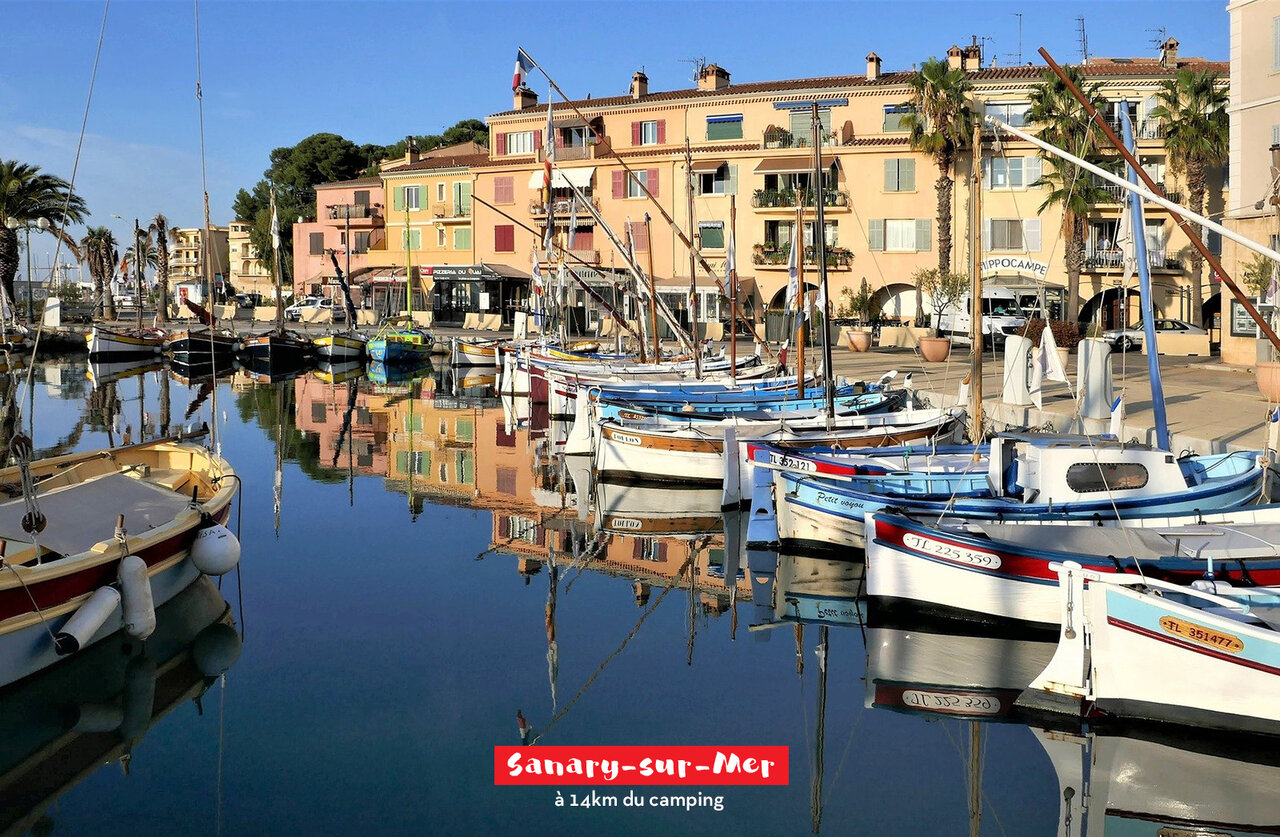 Sanary-sur-Mer harbor with traditional boats and colorful buildings, a must-visit.