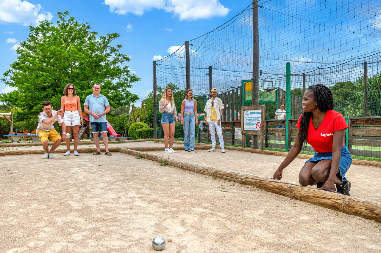 People playing p�tanque on a dedicated court at CAPFUN Malissonne campsite in LA CADIERE D'AZUR.