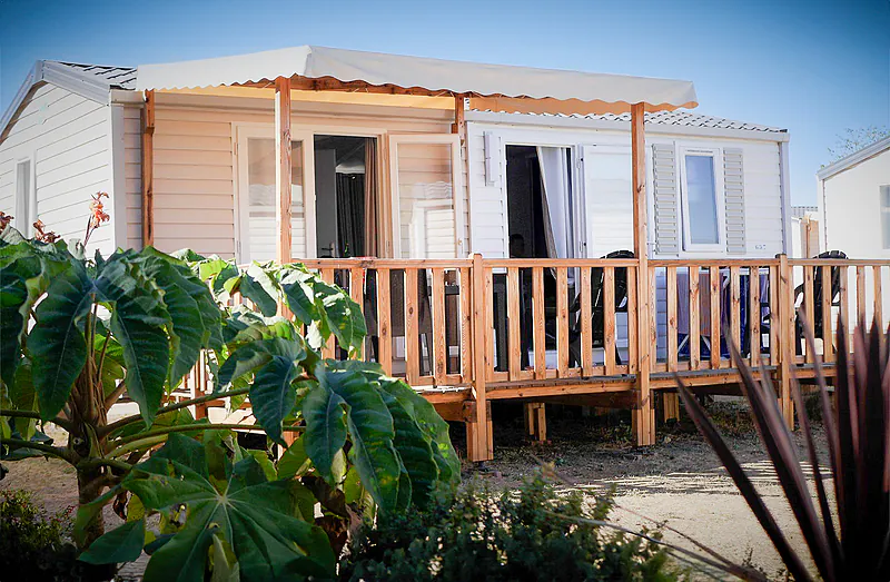Mobile home with covered terrace at VAGUES OCEANES Manoir de Balkos campsite