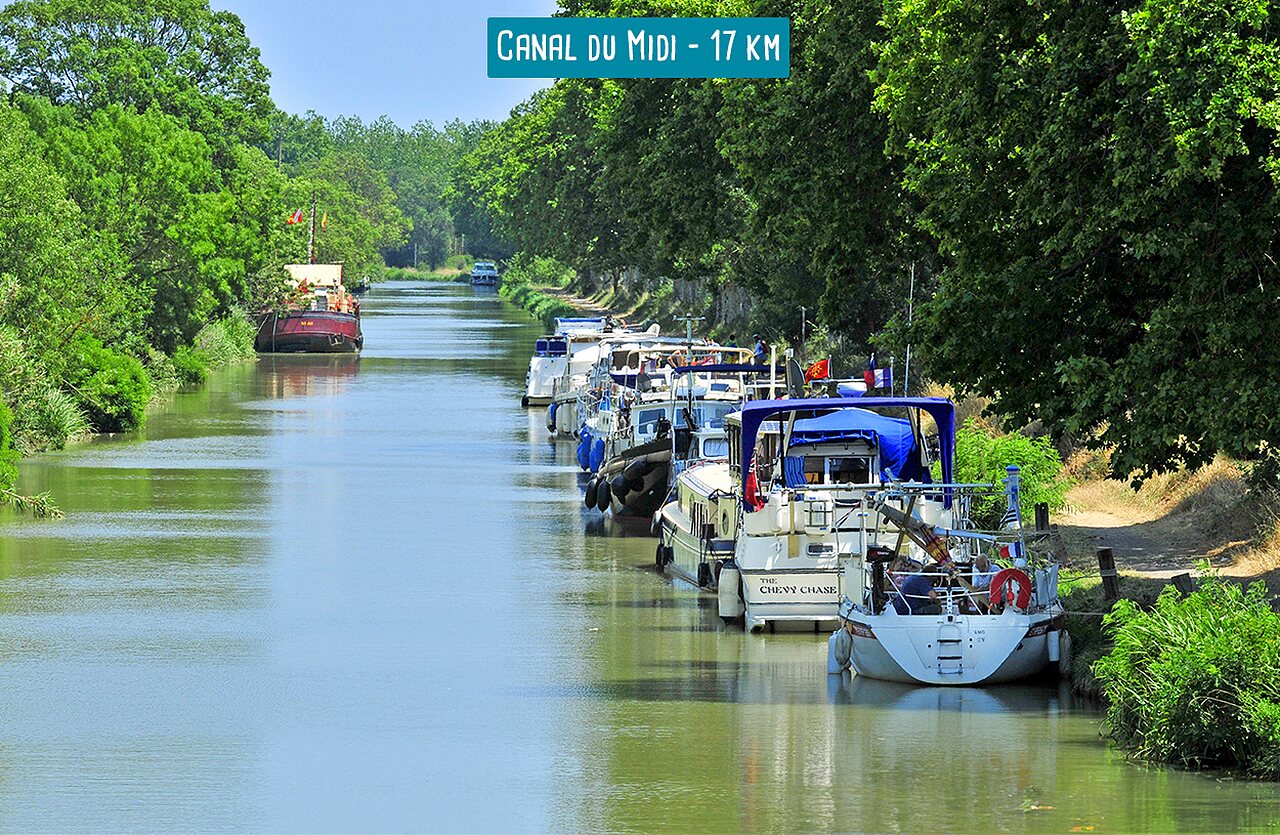 Boats moored along the Canal du Midi, historic waterway in Southern France.