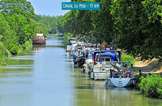 Boats moored along the Canal du Midi, historic waterway in Southern France.