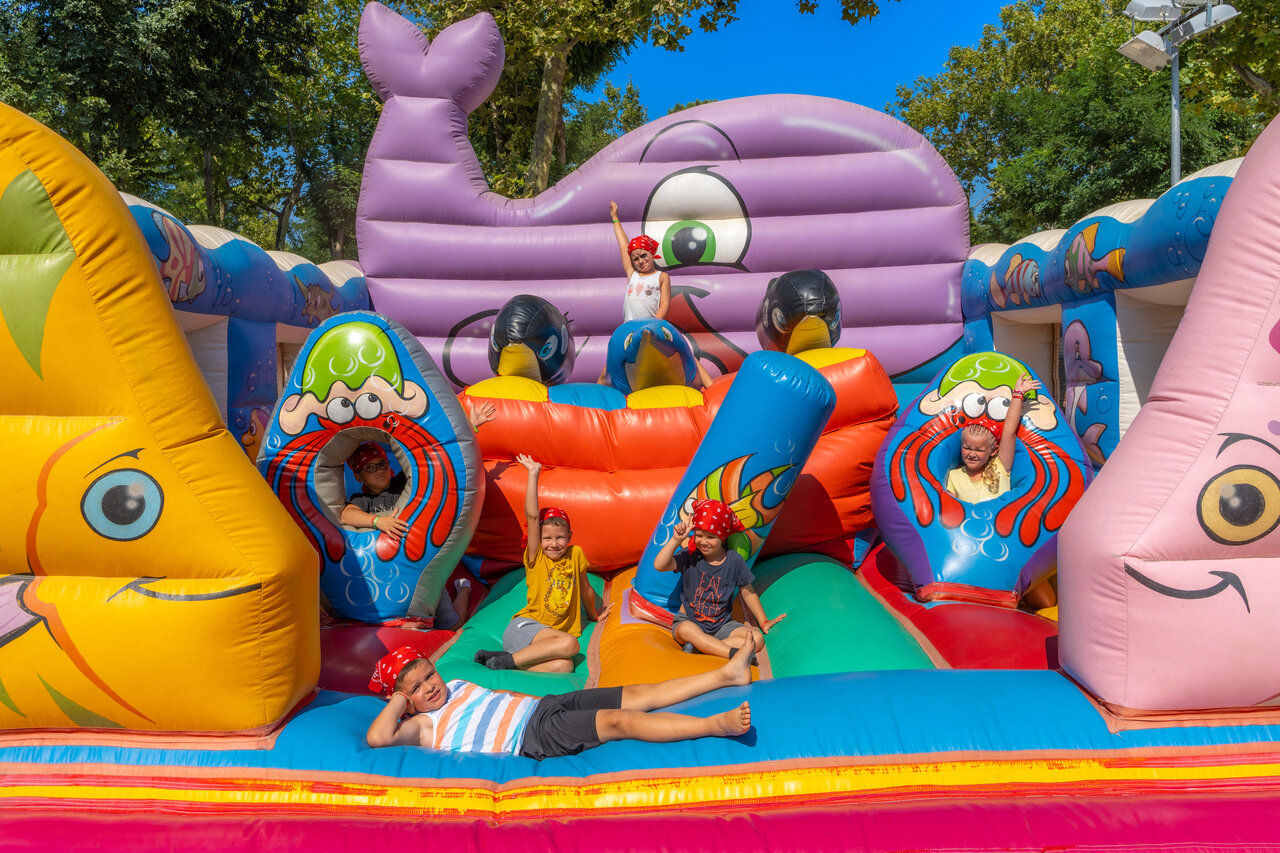 Giant inflatable with happy children at camping VAGUES OCEANES Marinette in Ste Marie La Mer (66).