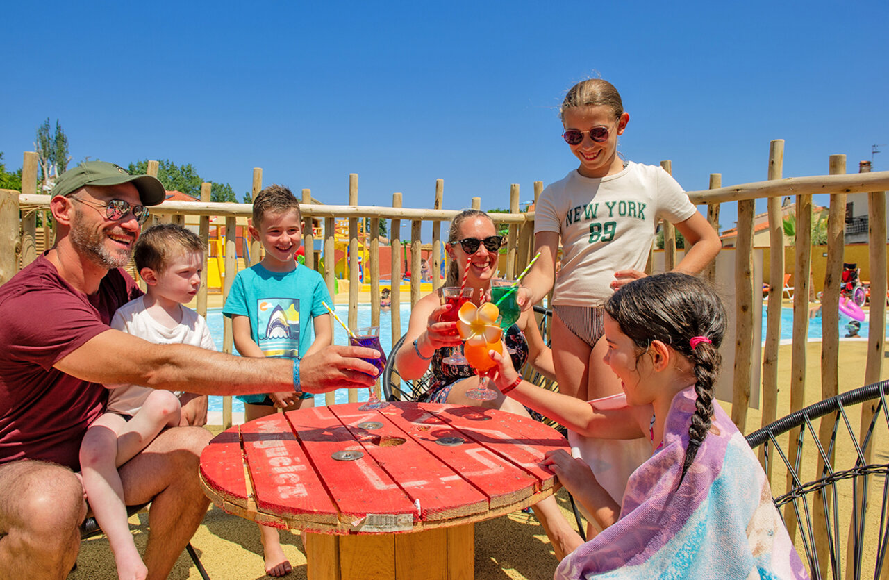 Smiling family pool at VAGUES OCEANES Marinette campsite in Ste Marie La Mer (66).