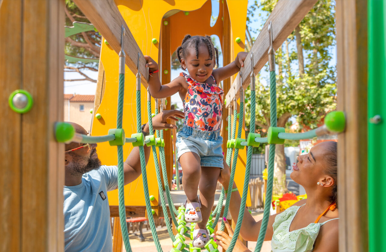 Little girl on rope bridge, at camping VAGUES OCEANES Marinette in Ste Marie La Mer (66).