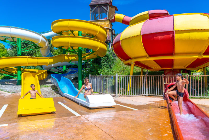 Colorful water slides and water games for children at CAPFUN Merle Roux campsite in Baix (07).