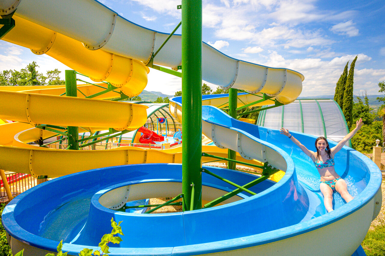 Young woman on water slide, water park CAPFUN Merle Roux, Baix (07).