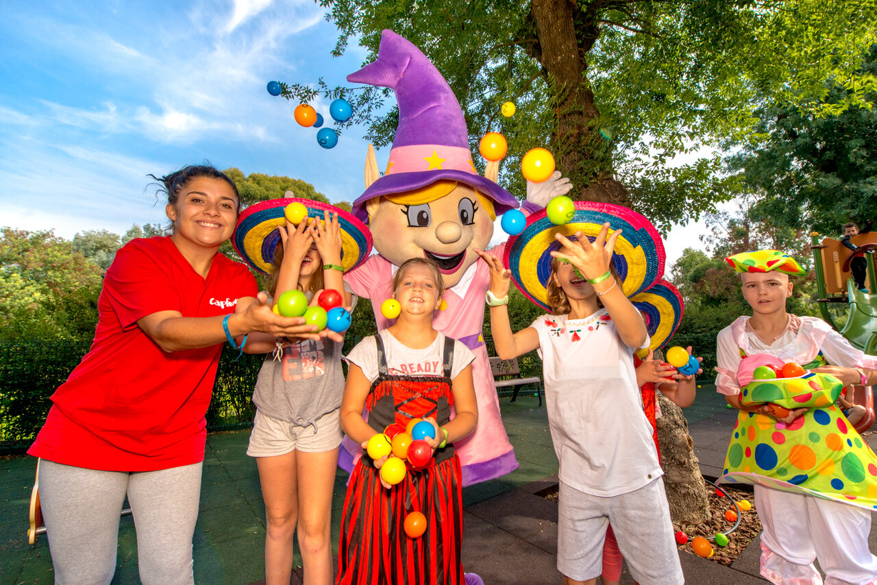 Animator, children and Capfun mascot with balls at CAPFUN Merle Roux campsite in Baix (07).