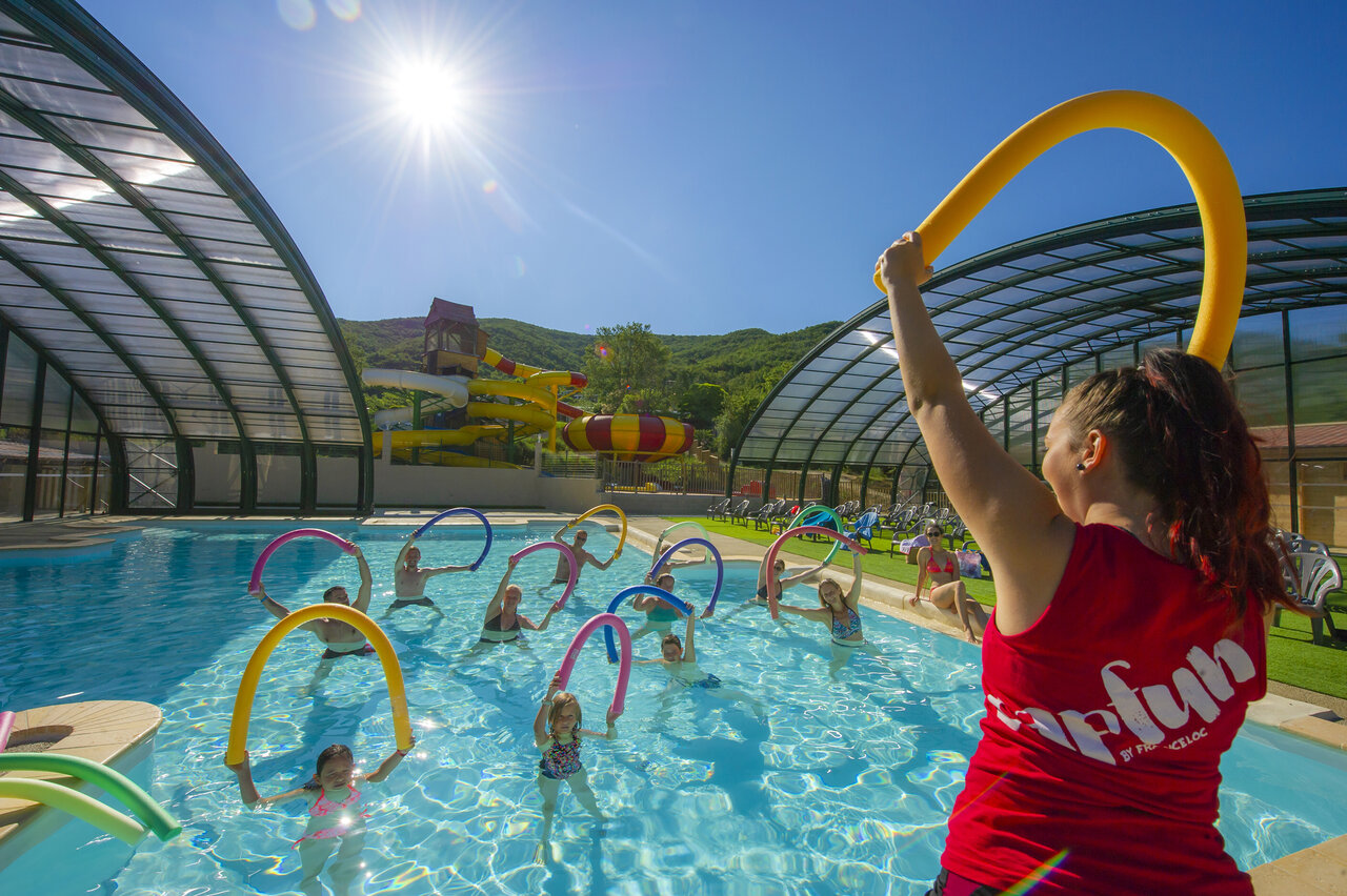 Indoor pool, water slides and aqua gym at CAPFUN Merle Roux campsite in Baix.