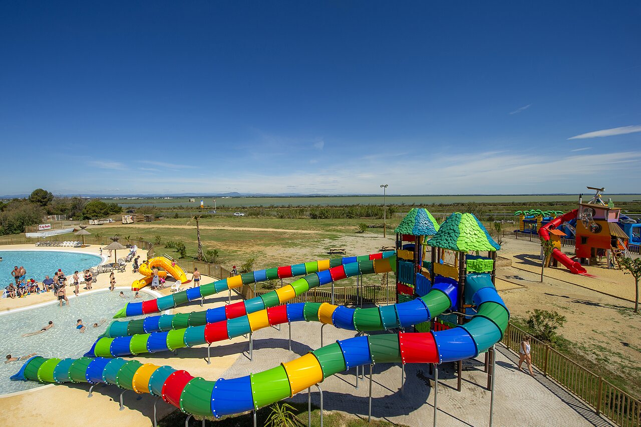 Colorful water slides and family swimming pool at CAPFUN Mille P�pites campsite in Carnon (34).