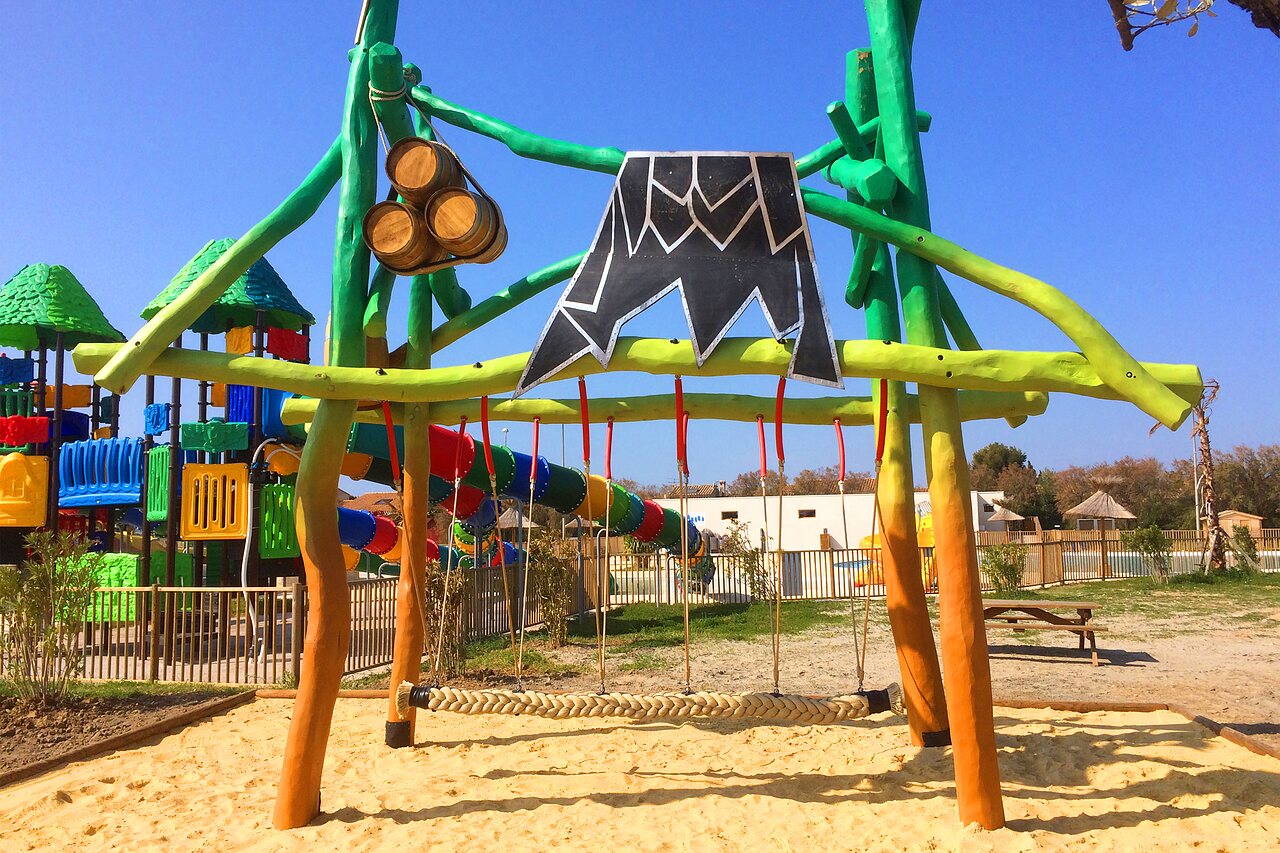 Themed playground, slides, swing at CAPFUN Mille P�pites campsite in Carnon.