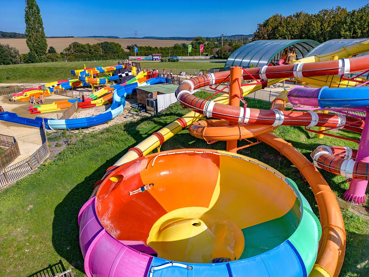 Colorful water slides and water games at CAPFUN Mirabelle campsite in VOLSTROFF (57).