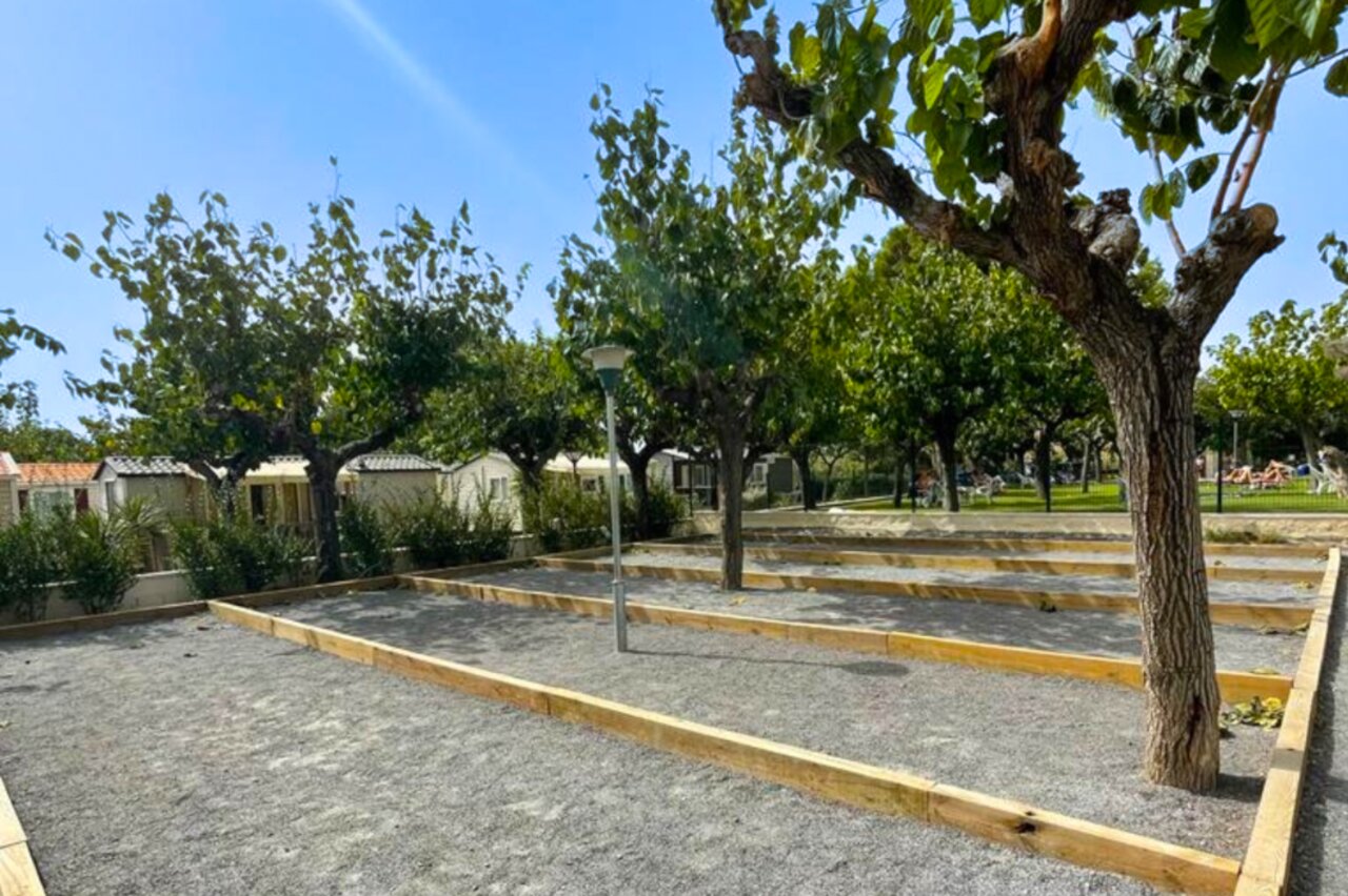 Shaded p�tanque courts and Mobile homes at CAPFUN Mirmanda campsite in Cambrils - Vinyols i els Arcs.