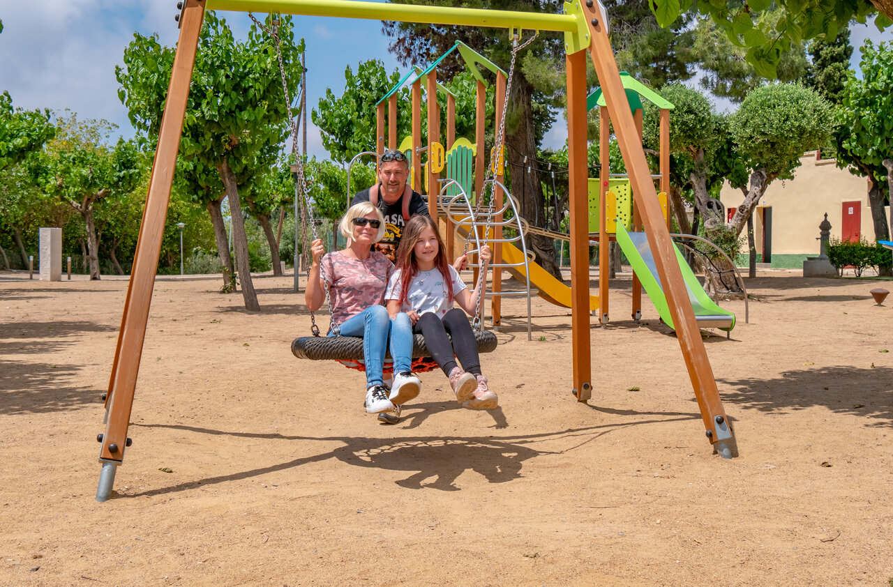 Family on tire swing, playground at CAPFUN Mirmanda campsite in Cambrils - Vinyols i els Arcs (43).