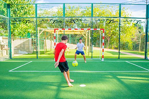 Football game on multisport field at CAPFUN Mirmanda campsite in Cambrils.