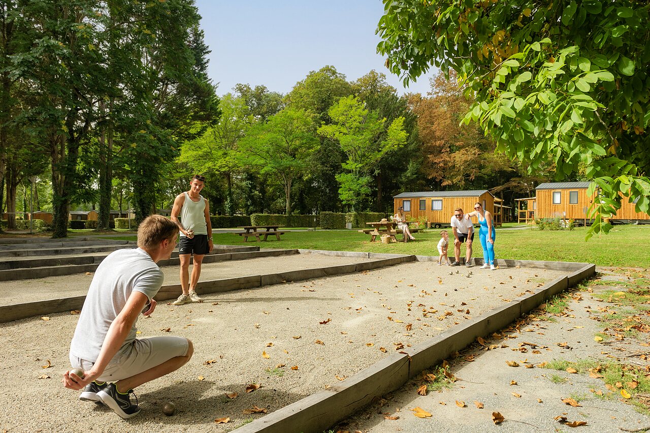 Petanque court, holidaymakers playing at CAPFUN Montsabert campsite in COUTURES (49).