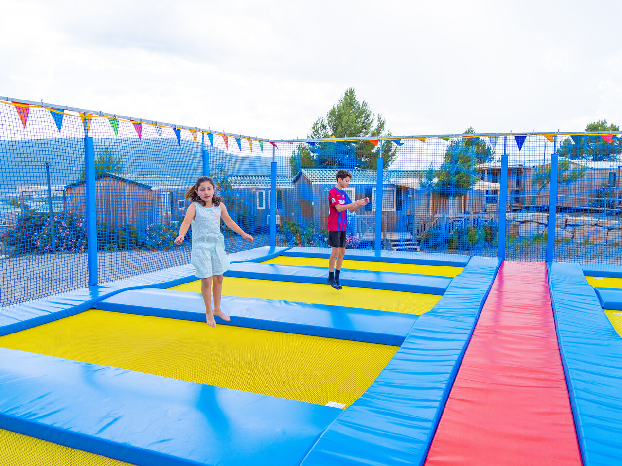 Children having fun on trampolines, Mobile homes at CAPFUN Montblanc Park campsite in Montblanc (43).